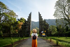 Woman backpacker walking toward the Handara Gate in Bali, Indonesia
